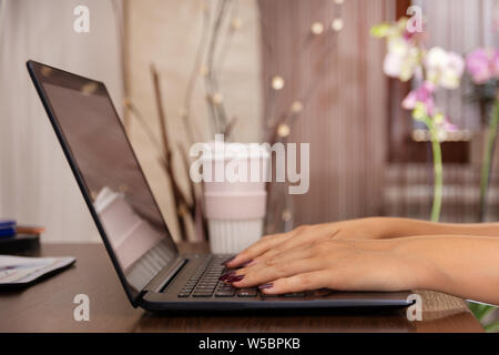 Working at home with laptop woman writing a blog. Female hands on the keyboard. Education concept. Close up, selective focus Stock Photo