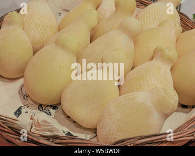 wicker basket with fresh caciocavallo, typical southern Italian cheese Stock Photo