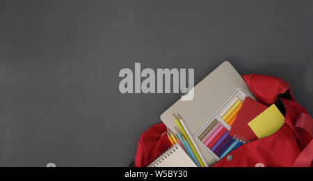 Composition with backpack, school stationery and copy space on grey desk Stock Photo