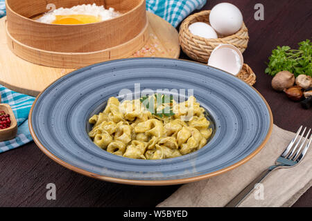 Conchiglie pasta. Italian pasta shells with mushrooms and tomato sauce. Stock Photo