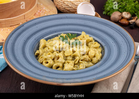 Conchiglie pasta. Italian pasta shells with mushrooms and tomato sauce. Stock Photo