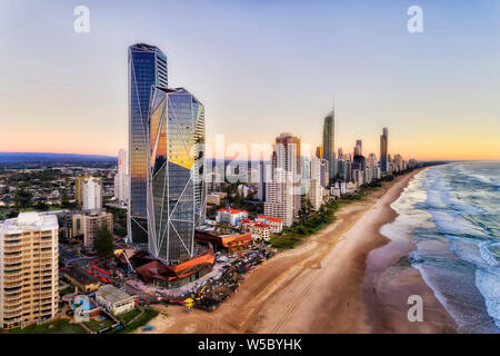Modern architecture of high-rise towers on waterfront of Pacific ocean above wide and long sandy beach - Surfers Paradise in Australian Gold Coast.