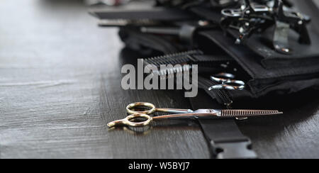 Close-up view of hairdresser's tool on black wooden table Stock Photo