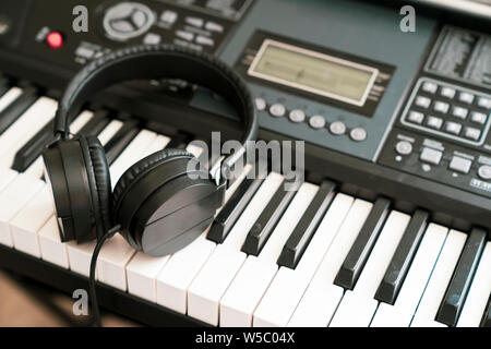 Headphones on musical synthesizer keyboard Stock Photo