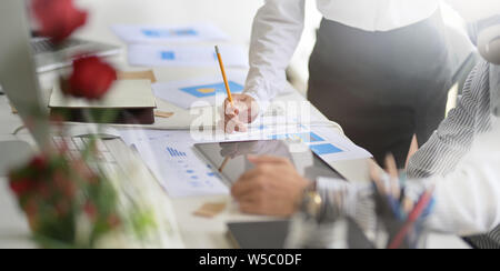 Young successful designers team brainstorming their upcoming project while working on tablet computer Stock Photo