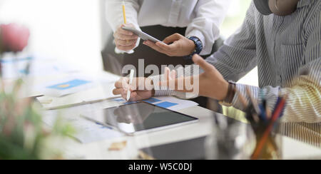 Young professional business team brainstorming their upcoming project Stock Photo