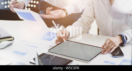 Young professional UI UX developers working on their project while using tablet in workspace Stock Photo