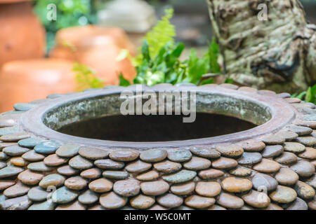 Gigantic jar, Warer jar with stone pattern in the garden Stock Photo