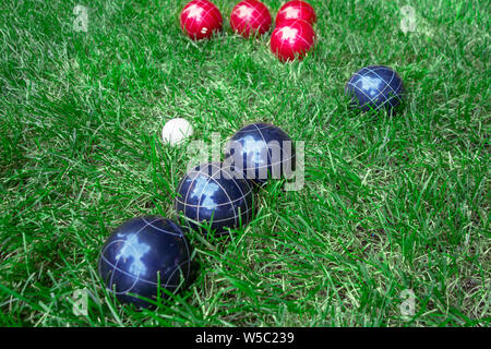 Red, white and blue european bocci balls on green lawn Stock Photo