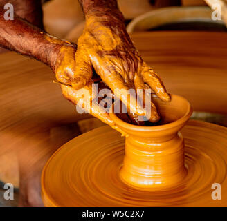Madurai, India, Mar 10, 2018 - Man forms bowl on a manual pottery wheel with no electricity Stock Photo
