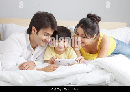Family using smart phone at home Stock Photo