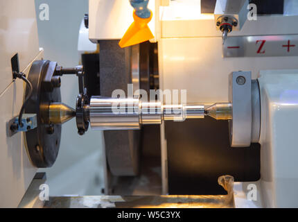 High precision cylindrical grinding machine working on steel shaft Stock Photo