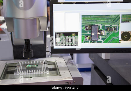 Vision measuring instrument inspecting PCB circuit board Stock Photo