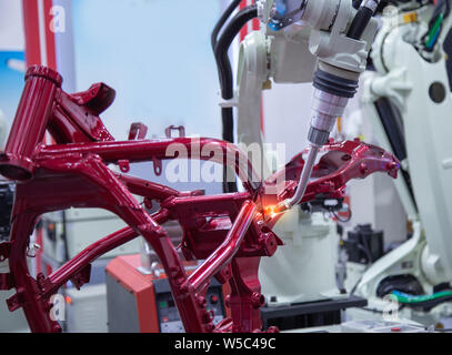 Automated robotic arm welding in automotive industry Stock Photo