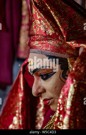 Munnar, India, Mar 11, 2018 - Traditional Indian dancer adjusts his costume prior to show Stock Photo