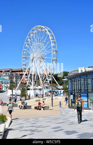 Bournemouth blue sky summer holiday & seaside resort pier approach pedestrian zone & tourist information centre big wheel  beyond Dorset England UK Stock Photo