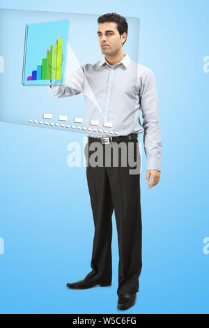 Businessman analyzing financial data on advanced touch screen monitor Stock Photo
