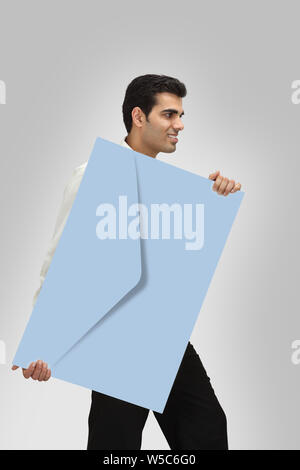 Man with big envelope in hand Stock Photo