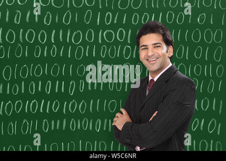 Businessman smiling with his arms crossed Stock Photo