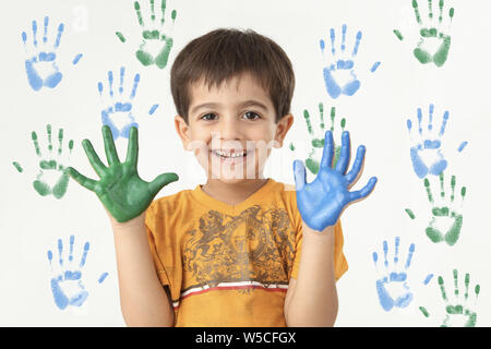Portrait of a boy showing painted hands Stock Photo