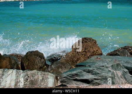 Waves hitting rocks at the Black Sea, Romania, colorful blue sea - Can be used for tourism ads or anything else Stock Photo