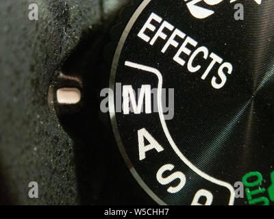 Macro of a Nikon DSLR camera mode dial turned on manual mode Stock Photo