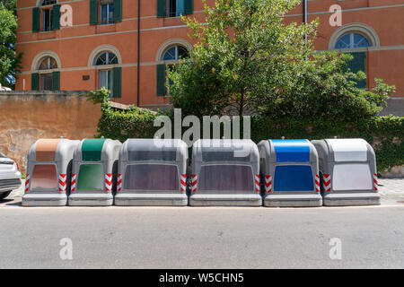 different garbage cans stand at the street in a big city Stock Photo