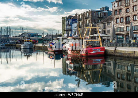 Sutton Harbour, formerly known as Sutton Pool, is the original port of the City of Plymouth the historic Barbican district in Devon, England. UK. Stock Photo