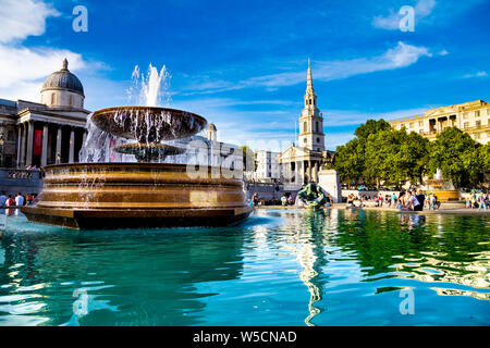Trafalgar Square fountain with St Martin-in-the-Fields church and National Gallery in the background, London, UK Stock Photo