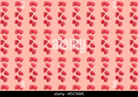 Fruit pattern. Colorful of fresh raspberries texture slices on coral pastel background. From top view. Photography collage. Stock Photo