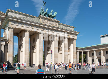2019-24-07 Berlin, Germany: groups of tourists at Pariser Platz looking at Brandenburg Gate on sunny summer day Stock Photo