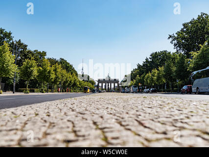 low angle view of Brandenburg Gate and 17 June Street in Berlin, Germany on sunny summer day