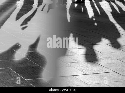 Silhouettes and Shadows of People on Sidewalk as Background