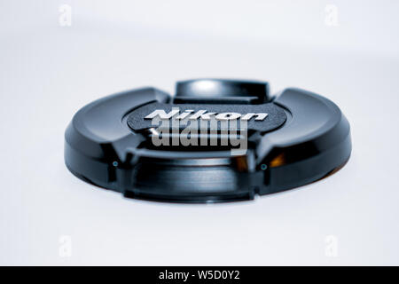 A Nikon lens cap with a white background - High contrast photo Stock Photo