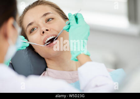 Portrait of beautiful young woman in dental chair during medical check up, copy space Stock Photo
