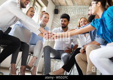 Business, startup, gesture, people and teamwork concept - happy creative team in office Stock Photo