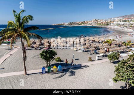 People relaxing and enjoying the warm sunshine on Playa de Torviscas, Costa Adeje Stock Photo