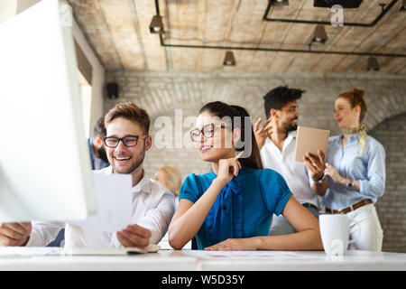 Happy creative team in office. Business, startup, design, people and teamwork concept Stock Photo