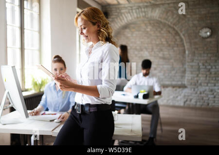 Group of business professionals having a meeting. Diverse group of designers smiling at the office. Stock Photo