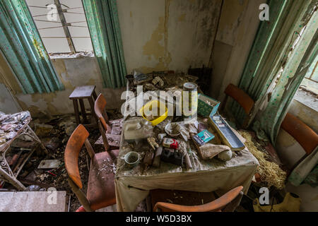 The interior of the abandoned house with household items in Ma Wan village, Hong Kong Stock Photo
