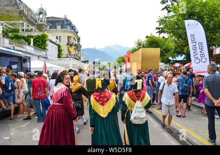 Vevey, Switzerland - July 26 2019: People in costumes celebrate Fete des Vignerons 2019. Traditional festival pays homage to viticultural traditions in Lavaux wine region. Organized once in 20-25 years, once in a generation, since 18th century. It was honoured as the first living tradition in Switzerland to received UNESCO recognition. Festival takes place from 18th July till 11th August 2019. Stock Photo