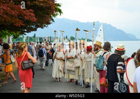 Vevey, Switzerland - July 26 2019: People in costumes celebrate Fete des Vignerons 2019. Traditional festival pays homage to viticultural traditions in Lavaux wine region. Organized once in 20-25 years, once in a generation, since 18th century. It was honoured as the first living tradition in Switzerland to received UNESCO recognition. Festival takes place from 18th July till 11th August 2019. Stock Photo