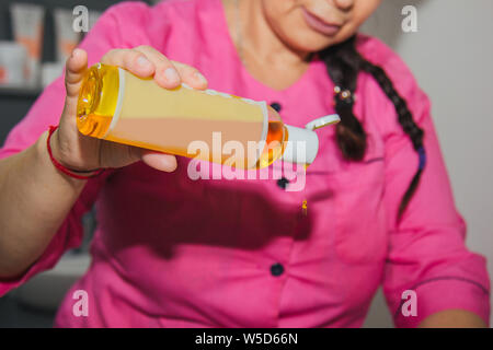 professional therapeutic massage using massage oil. Woman doctor massages in a massage room. body and health care. procedure for recovery from pain af Stock Photo