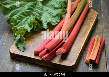 Fresh rhubarb on wooden board Stock Photo