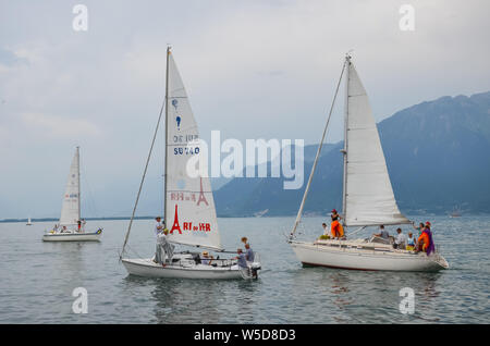 Vevey, Switzerland - July 26 2019: People on sailboats celebrate Fete des Vignerons 2019. Traditional festival pays homage to viticultural traditions in Lavaux wine region. Organized once in 20-25 years, since 18th century. It was honoured as the first living tradition in Switzerland to received UNESCO recognition. Festival takes place from 18th July till 11th August 2019. Stock Photo