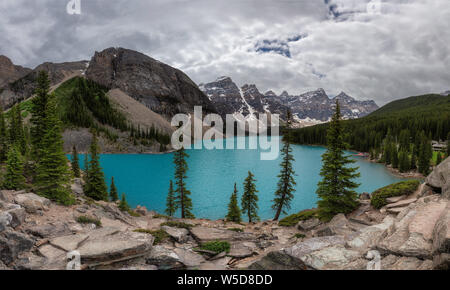 Panoramic view of Moraine lake in Banff National Park at cloudy day, Canada. Stock Photo