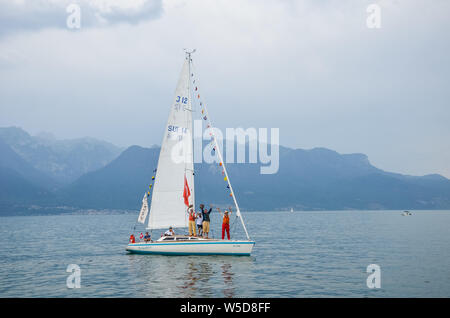 Vevey, Switzerland - July 26 2019: People on sailboats celebrate Fete des Vignerons 2019. Traditional festival pays homage to viticultural traditions in Lavaux wine region. Organized once in 20-25 years, since 18th century. It was honoured as the first living tradition in Switzerland to received UNESCO recognition. Festival takes place from 18th July till 11th August 2019. Stock Photo