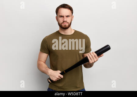 Angry nervous unhappy man with a bat bat isolated on white background. isolated white background. studio shot. Stock Photo