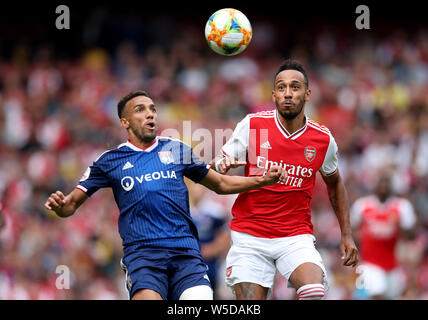 Lyon's Marcal (left) and Arsenal's Pierre-Emerick Aubameyang (right) battle for the ball during the Emirates Cup match at the Emirates Stadium, London. Stock Photo