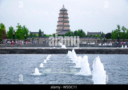 The North Square Tang Cultural area water fountain and great wild goose pagoda in Shaanxi province on an overcast day. Stock Photo